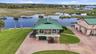 Elevated aerial showing the residence positioned directly along the waterfront.