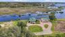 Expansive aerial showing the property surrounded by natural wetlands and waterways.