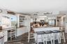 Kitchen and breakfast bar providing abundant seating and workspace.