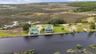 Wide aerial illustrating the property's waterfront position within the surrounding coastal environment.