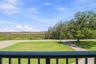Elevated view across the property toward the natural coastal wetlands and Gulf of America.