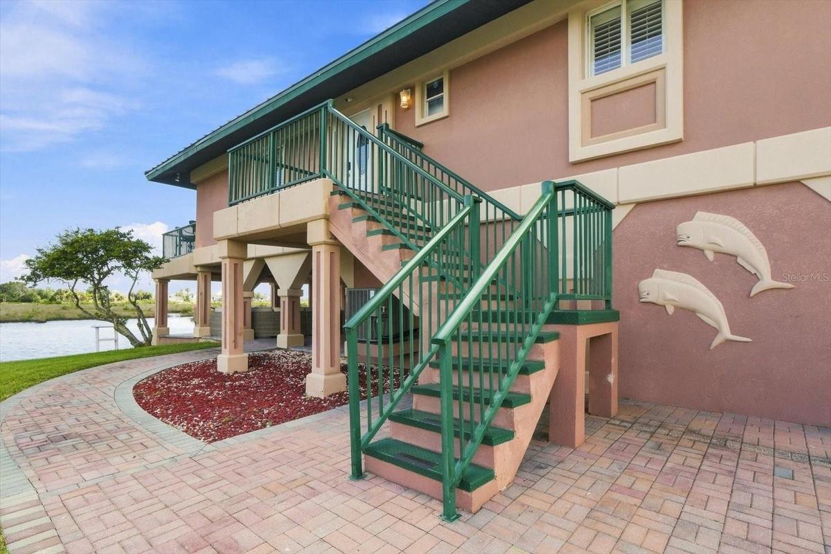 Exterior stairway providing access to the upper-level residence.