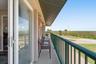 Covered balcony extending along the side of the residence.