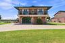 Front exterior view of the elevated waterfront residence.