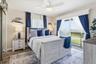 Guest bedroom with direct access to the waterfront balcony.