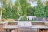 Built-in outdoor grill with stone surround and counter space