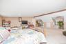 Spacious room featuring carpeting, recessed lighting, and sloped ceiling details
