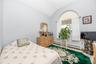 Arched window with sunburst shade and drapery rods