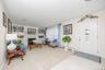 Recessed fireplace with a light-toned surround, built-in shelving, and light-toned wall-to-wall carpeting