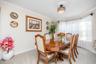 Recessed lighting fixture with decorative ceiling medallion, bay window with sheer curtains, and light neutral wall paint