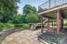 Sliders in the basement provide walk-out access to a beautifully manicured backyard, complete with a double deck and a fenced-in pool area that’s perf
