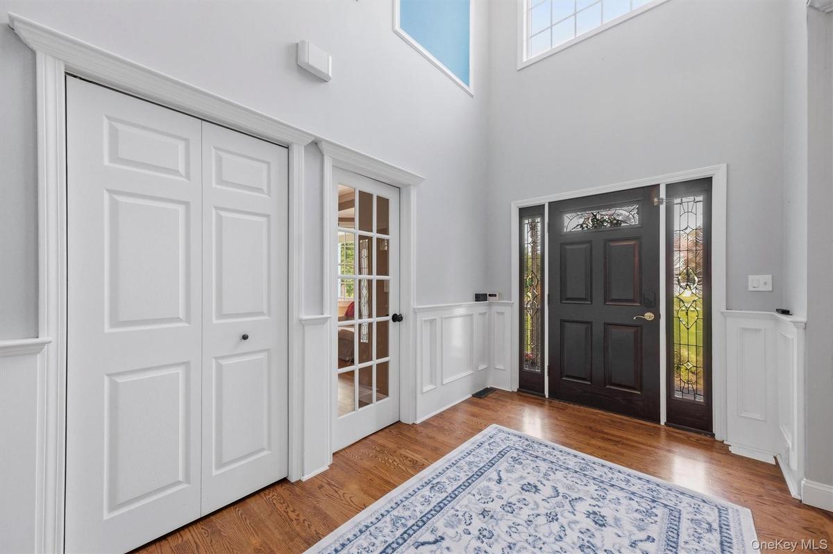 An expansive foyer with soaring vaulted ceilings welcomes you upon arrival.