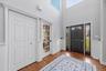 An expansive foyer with soaring vaulted ceilings welcomes you upon arrival.