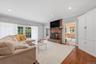 The family room features sliding glass doors that open to a two-tiered deck, as well as convenient access to an all-season sunporch.