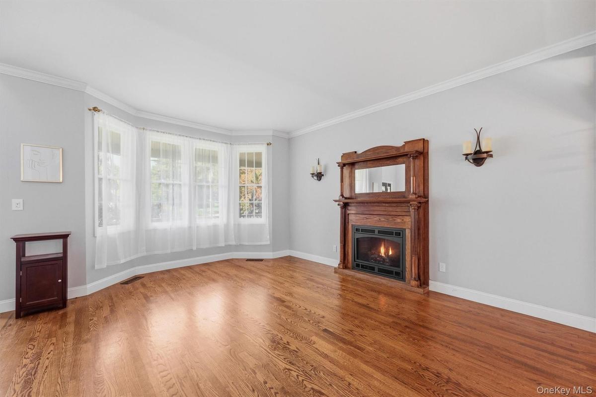 The living room offers plenty of light and a charming gas fireplace.