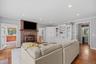 A more casual family room offers a place to watch TV by another (two-sided) gas fireplace.