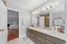 Primary bath with his and her sinks, a soaking tub and a shower.