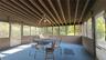 Screened porch featuring a slatted wood ceiling, ceiling fan, and extensive natural light