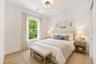 Virtually staged Bedroom 4 enjoys a private en-suite bath with direct exterior access to the lanai, providing an ideal guest retreat and future pool b