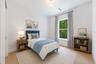 Virtually staged. Spacious bedroom 3 with impact-rated window, solid-core door, and convenient access to a full bath.