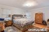 Primary Suite with door to backyard. Hardwood flooring throughout