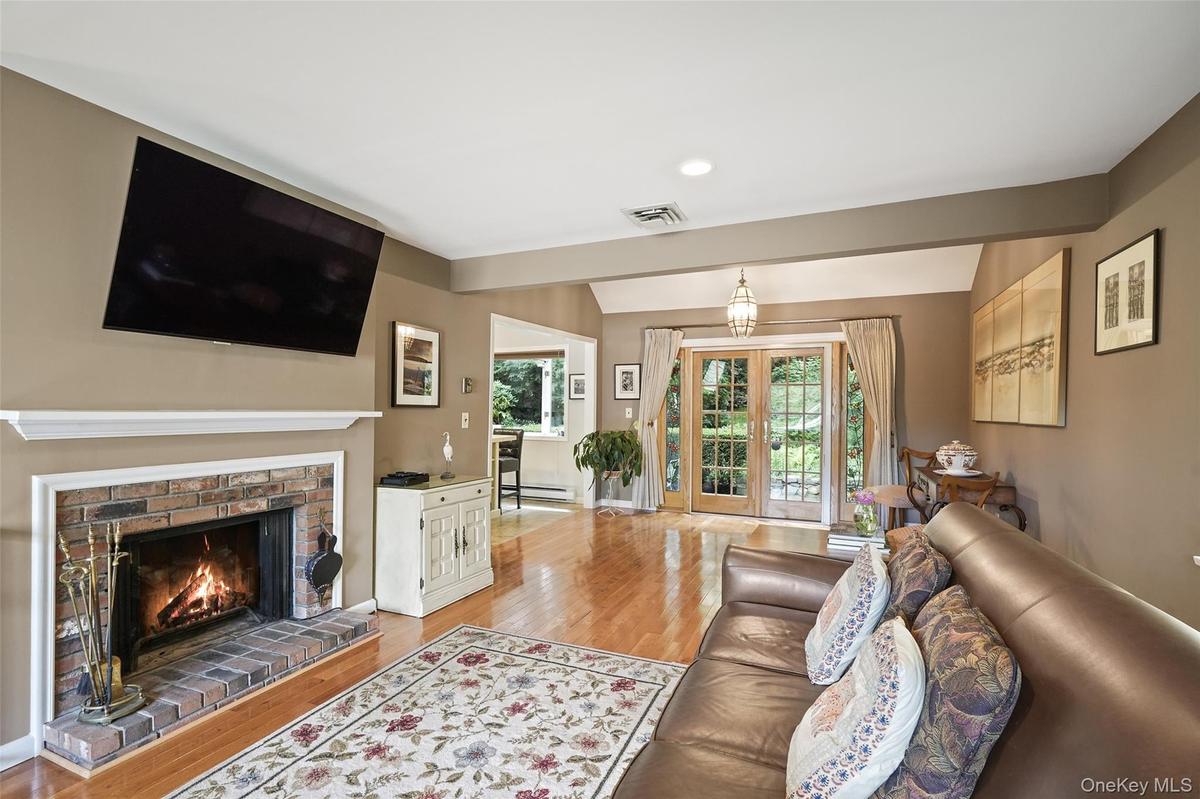 Great room includes living room with wood burning fireplace and dining area