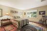 Spacious primary bedroom with window facing private backyard