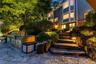 Close-up of the outdoor Kitchen at twilight, with natural stone steps from lower patio to upper patio
