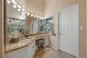 Primary Bedroom Dressing & Vanity Area with custom walk-in closet