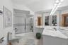 Large Full Bathroom with bathtub and sauna on lower level