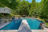 View from diving board of pool with infinity edge to the right