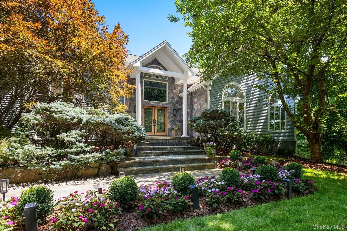Custom designed and built contemporary colonial with professional landscaping and privacy.