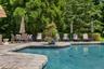 Free form pool with impressive patio surround with furniture included