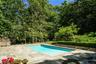 Note the gorgeous gardens behind the pool with grass areas to practice your favorite sports.