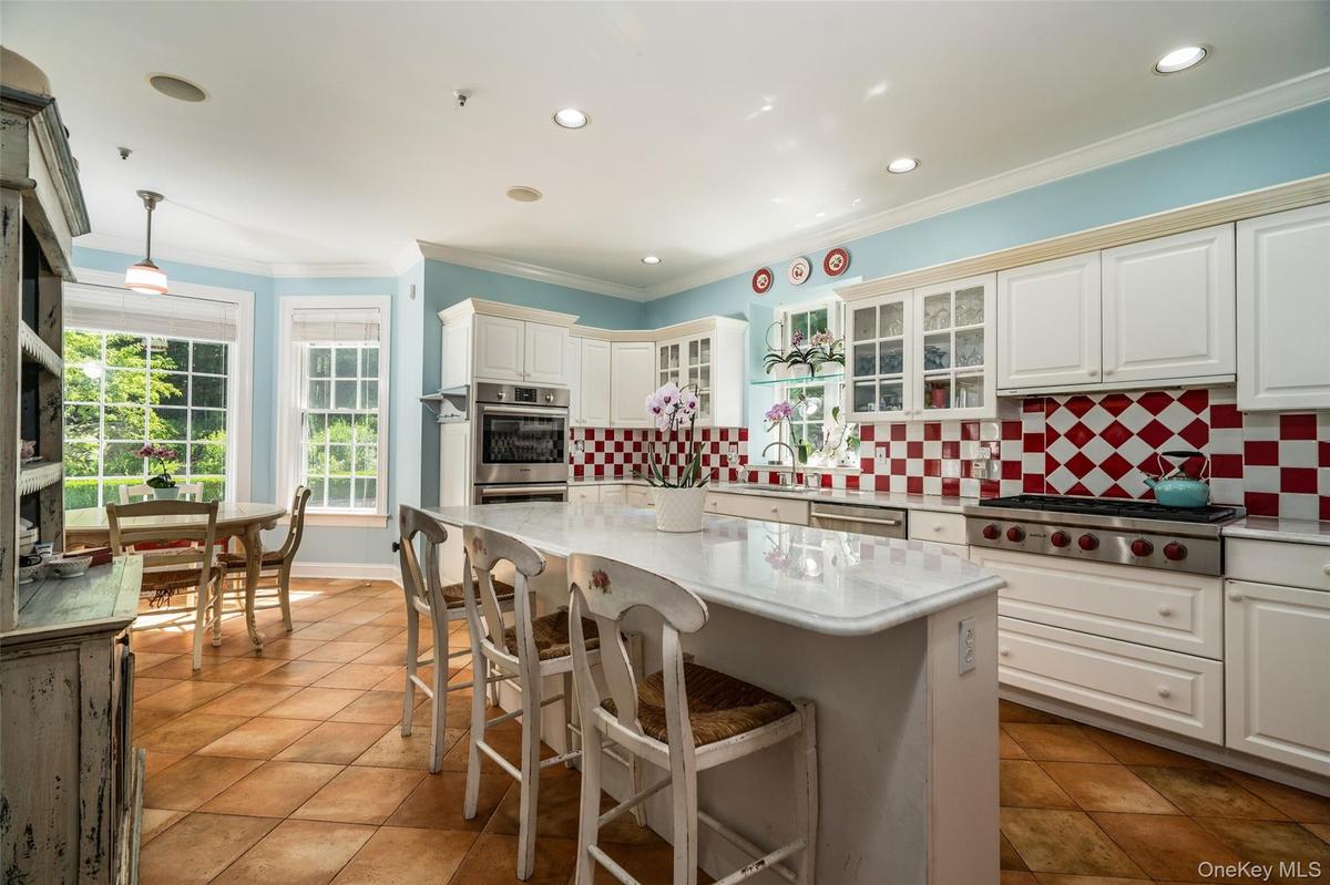 The heart of the home is light, bright, and ready for anything. With a chef-inspired island and elegant details, this kitchen flows seamlessly into a 