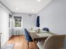 Wood-finish flooring with light blue walls and recessed ceiling lighting