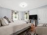 Bright and spacious bedroom with hardwood floors and plenty of natural light.