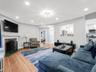 Hardwood flooring, recessed lighting, and a fireplace with a decorative screen
