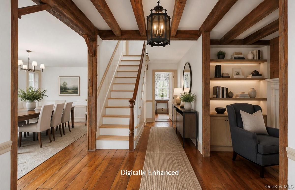 Beautiful entryway with exposed beams and wide pine floors