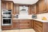 The beautifully appointed kitchen has high-end soft-close cabinetry and stainless appliances.