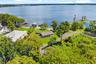 An exceptional opportunity to own one of the most compelling lakefront properties on Lake Cottage Lane, featuring an oversized homesite, expansive Lak