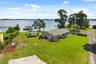 Lake Cottage Lane, featuring an oversized homesite, expansive Lake Sheen views, sandy shoreline, private dock and boatlift, and an existing 2BR/1.5BA 
