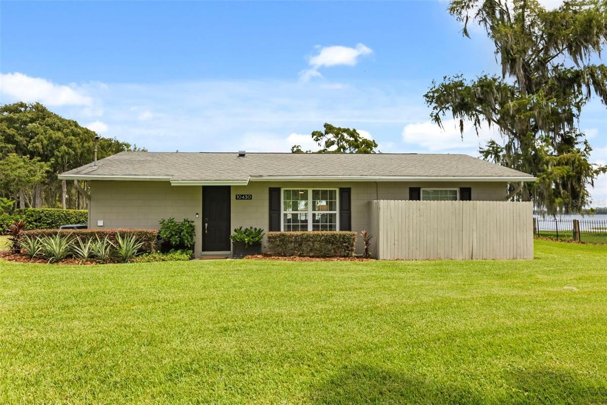 Lake Cottage Lane, featuring an oversized homesite, expansive Lake Sheen views, sandy shoreline, private dock and boatlift, and an existing 2BR/1.5BA 