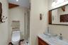 Bathroom featuring a vessel sink, a shower with a clear glass enclosure, and a vanity with a light-toned countertop