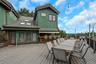 Expansive outdoor deck featuring a built-in bar, extensive railing, and string lighting