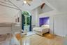 Hardwood flooring, vaulted ceilings with exposed beams, arched window, built-in bed nook, and ceiling fan