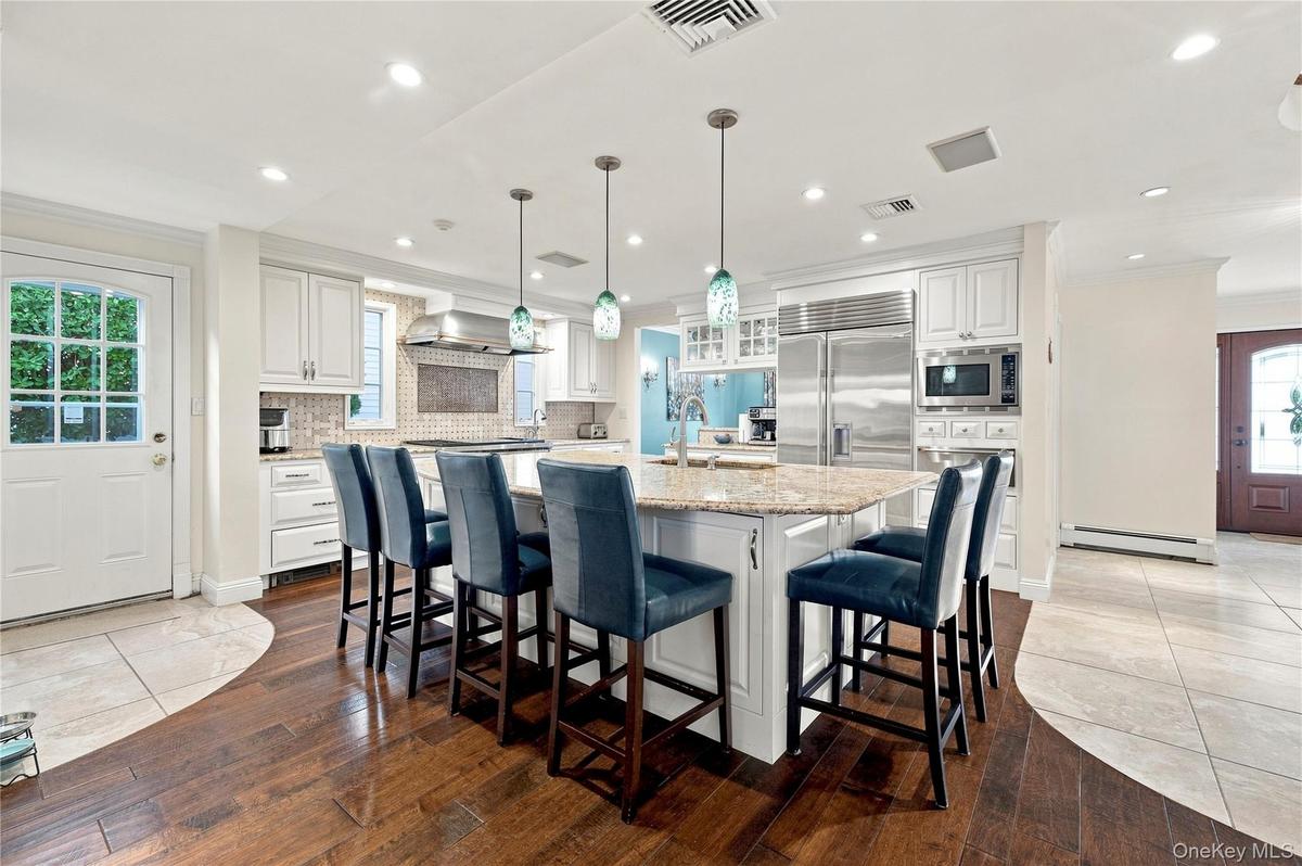 Top-of-the-line chef's open kitchen with island seating for 6.