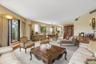 Sun-filled iving and dining areas with 2 sets of glass doors to wrap around balcony.