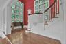 Walls of windows, with the leaded glass design preserved so well here, as throughout the rest of the home, welcome natural light to pour in and allows