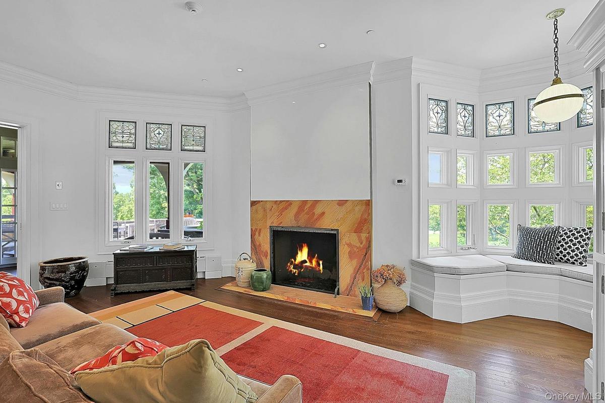 This room has its own fireplace and plenty of space for seating. Restored stained glass windows over new, energy efficient ones perfectly capture the 